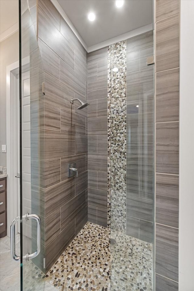 bathroom featuring recessed lighting, a shower stall, and vanity