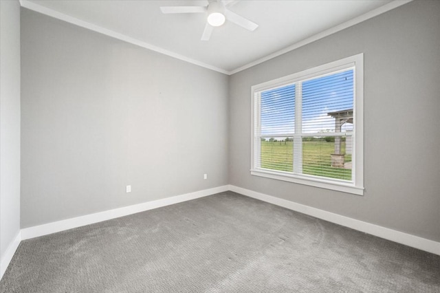 spare room featuring baseboards, carpet flooring, ornamental molding, and ceiling fan
