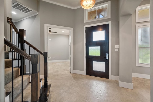 foyer featuring stairway, visible vents, ornamental molding, baseboards, and concrete floors