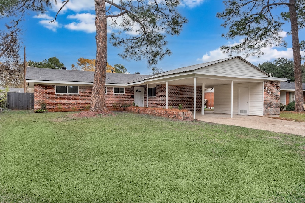 ranch-style house with a front lawn and a carport