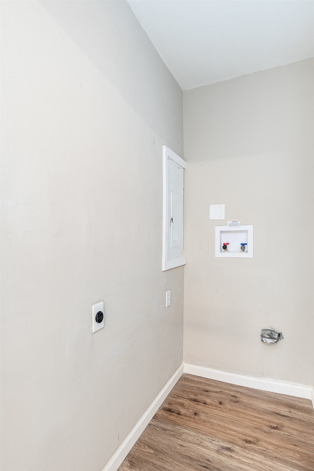 clothes washing area with electric dryer hookup, hardwood / wood-style floors, and washer hookup