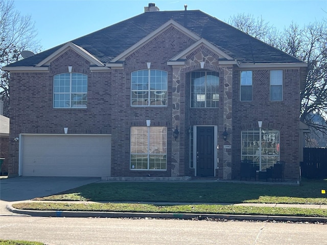 view of front of property with a front yard and a garage