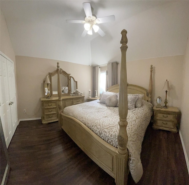 bedroom featuring a closet, dark wood-type flooring, ceiling fan, and lofted ceiling