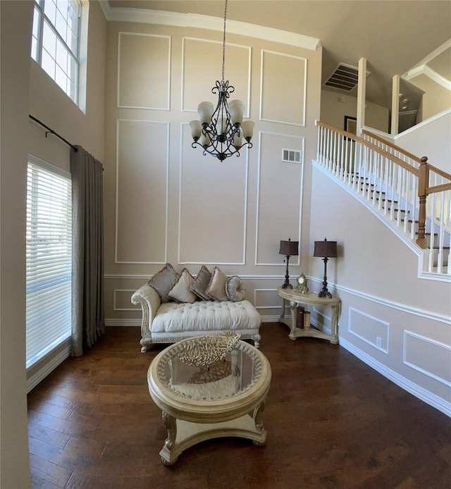 sitting room with a notable chandelier and dark hardwood / wood-style floors