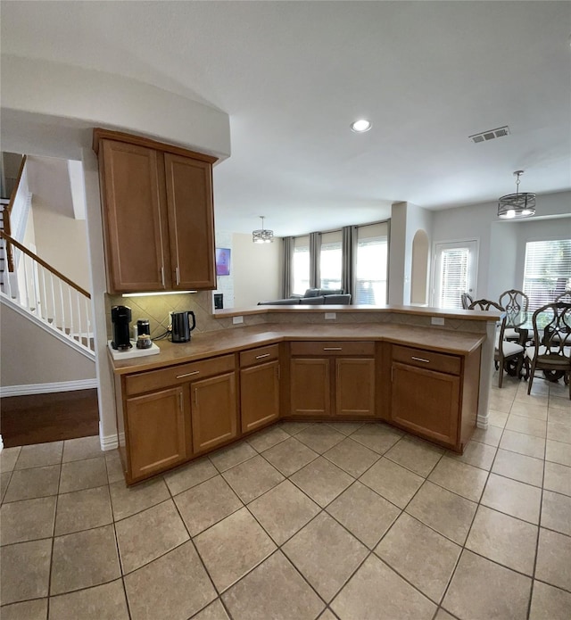 kitchen featuring decorative light fixtures, light tile patterned flooring, and an inviting chandelier