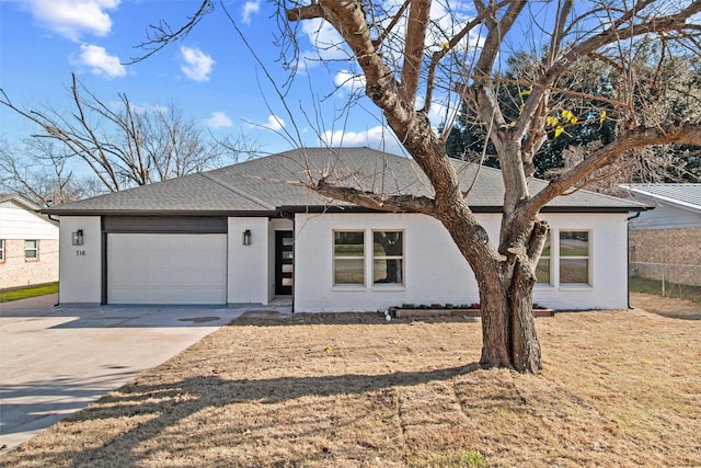 view of front facade featuring a garage and a front lawn