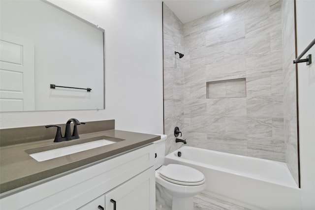 full bathroom with toilet, vanity, and tiled shower / bath