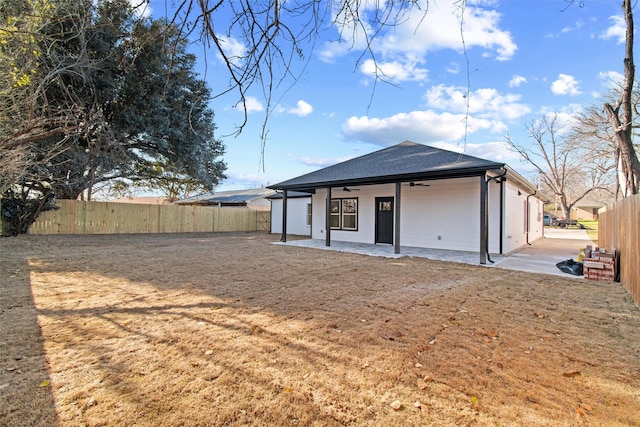 rear view of house featuring a patio area, ceiling fan, and a yard