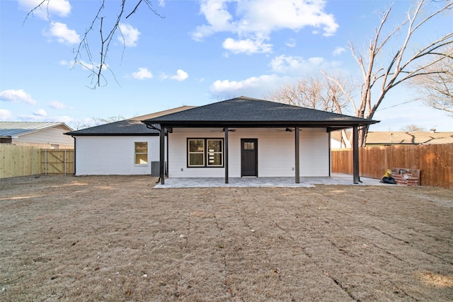 back of property with ceiling fan and a patio area