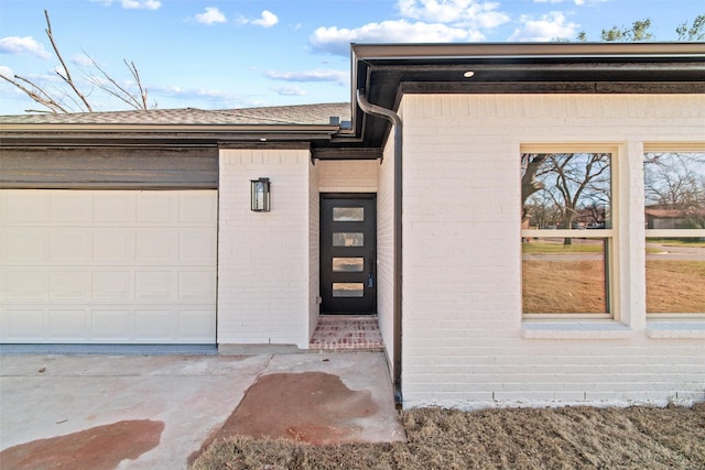 view of exterior entry with a garage