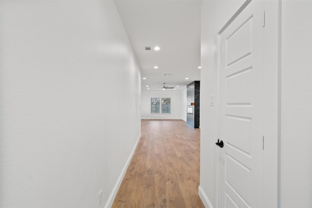 corridor with light wood-type flooring