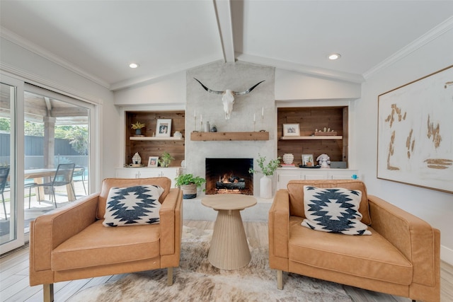 living room with light hardwood / wood-style floors, vaulted ceiling with beams, ornamental molding, a fireplace, and built in features