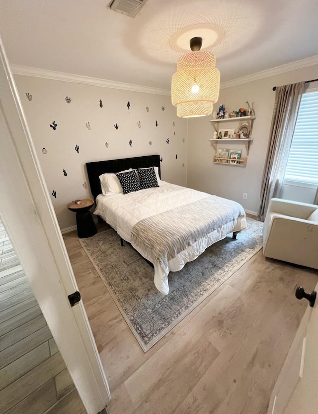 bedroom featuring crown molding and hardwood / wood-style flooring