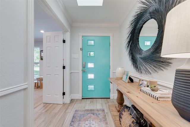 entryway with crown molding and light hardwood / wood-style flooring