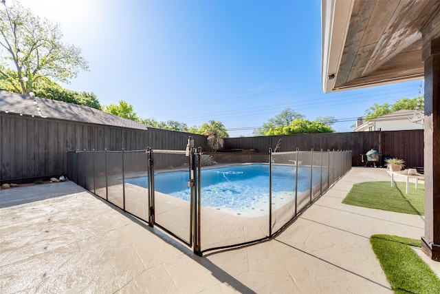 view of swimming pool featuring a patio area