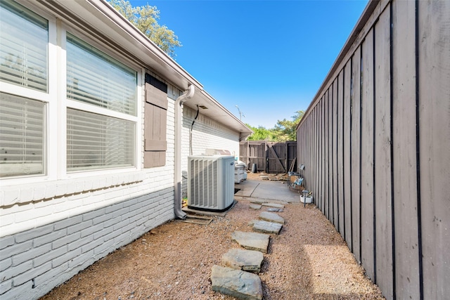 view of side of property featuring central AC and a patio area