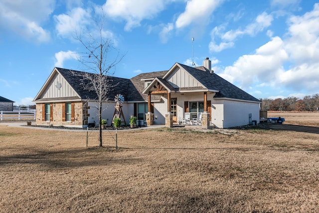 view of front of home with a porch and a front lawn