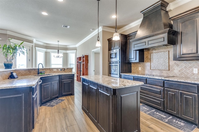 kitchen featuring a center island, tasteful backsplash, premium range hood, decorative light fixtures, and black electric cooktop