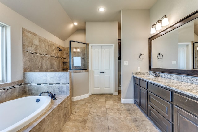 bathroom with vanity, independent shower and bath, and vaulted ceiling