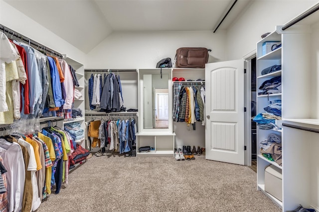 walk in closet with carpet flooring and lofted ceiling