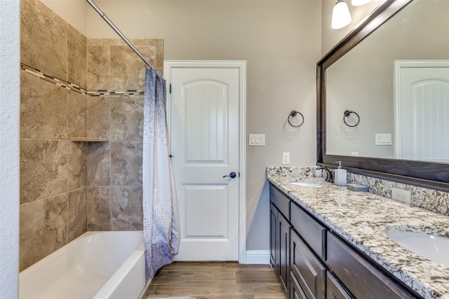 bathroom with hardwood / wood-style floors, shower / bath combination with curtain, and vanity