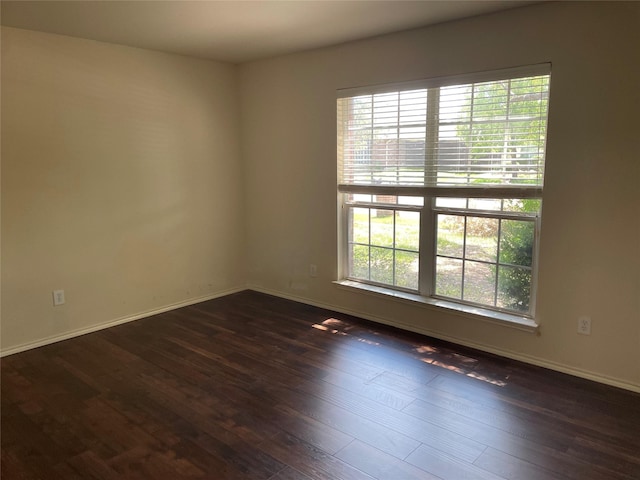 spare room with dark hardwood / wood-style flooring