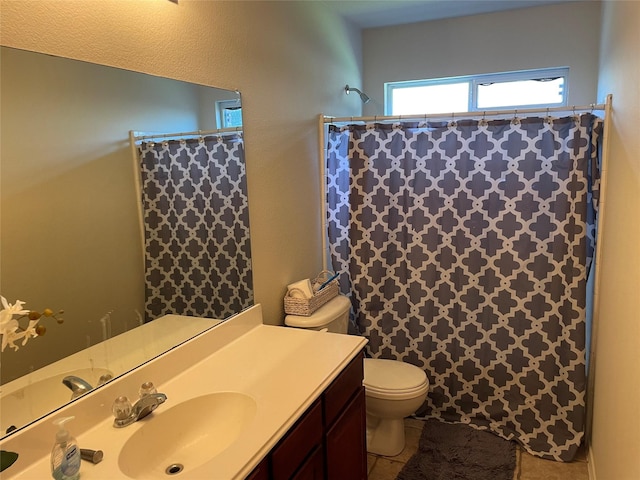 bathroom with tile patterned floors, vanity, curtained shower, and toilet