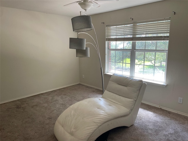 living area featuring carpet flooring and ceiling fan