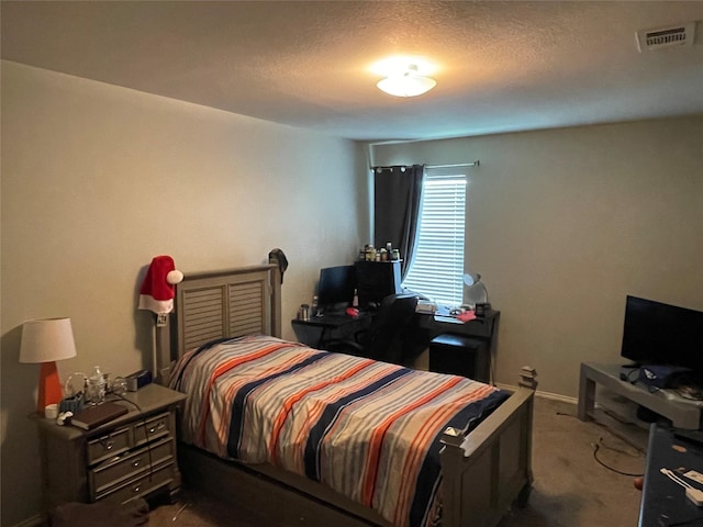 carpeted bedroom featuring a textured ceiling