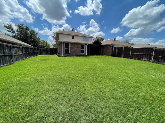 rear view of property featuring a lawn