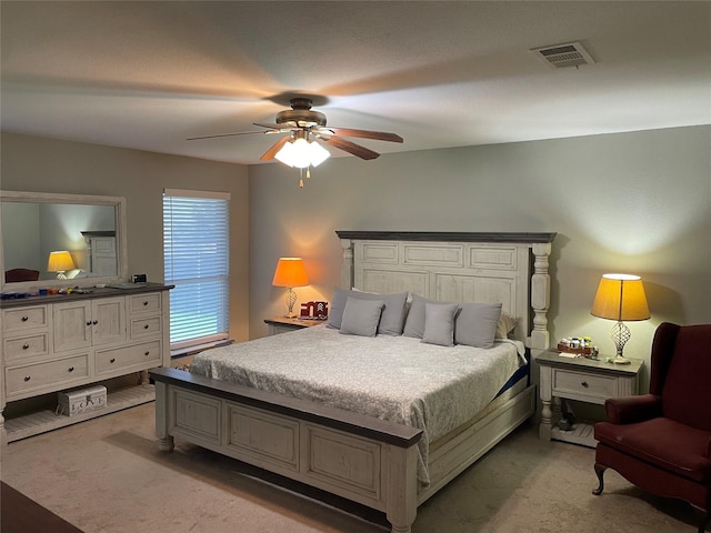 bedroom featuring light carpet and ceiling fan