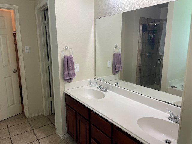 bathroom featuring tile patterned flooring, vanity, and a shower with shower door