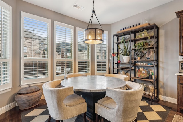 dining space with dark hardwood / wood-style floors