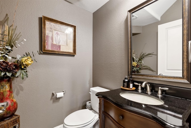 bathroom with toilet and vanity