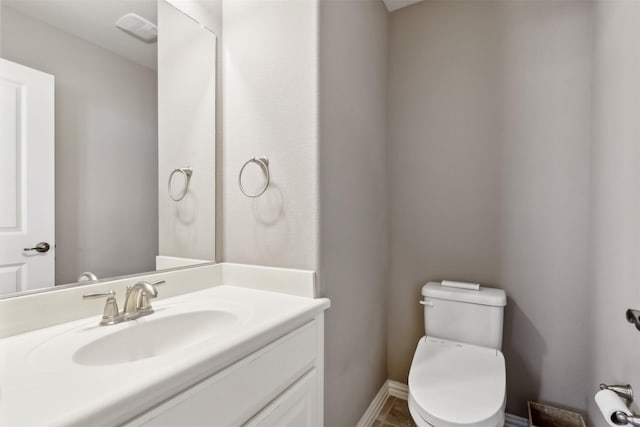 bathroom with toilet and vanity