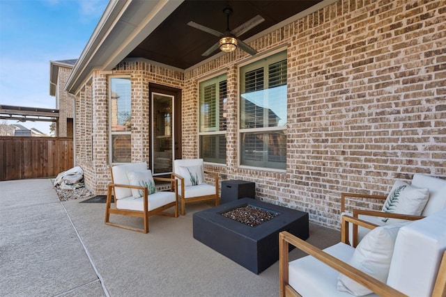 view of patio with ceiling fan and an outdoor living space with a fire pit