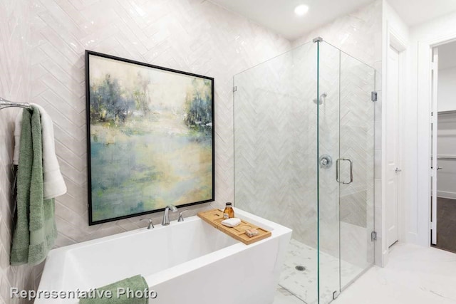 bathroom with plus walk in shower and tile walls