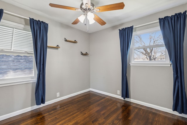 empty room with dark hardwood / wood-style floors and ceiling fan