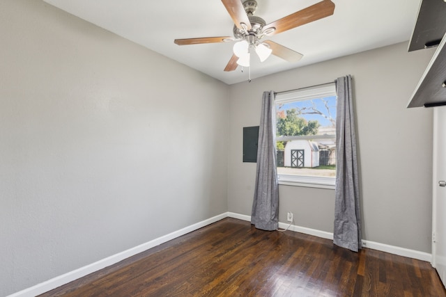 empty room with ceiling fan and dark hardwood / wood-style flooring