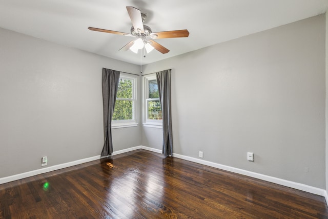 spare room featuring dark hardwood / wood-style flooring and ceiling fan