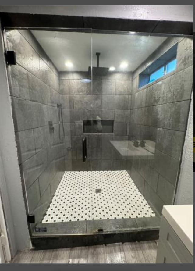 bathroom featuring hardwood / wood-style flooring and an enclosed shower