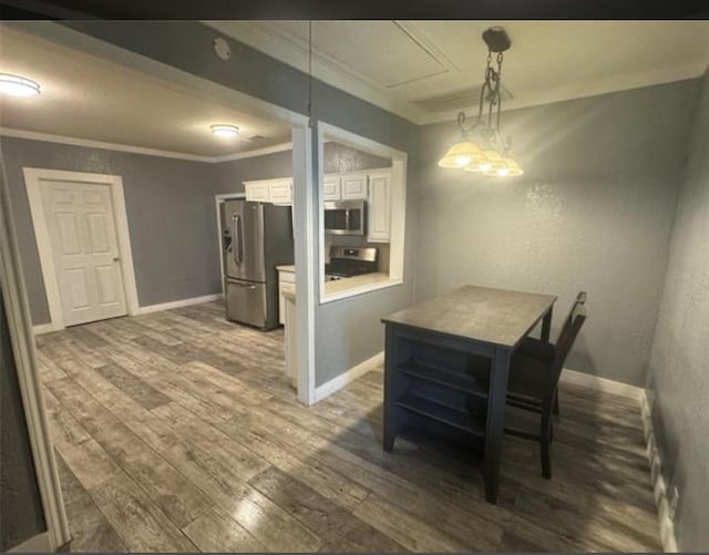 dining area featuring dark hardwood / wood-style flooring and ornamental molding