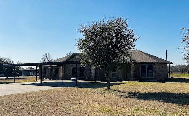 exterior space with a lawn and a carport