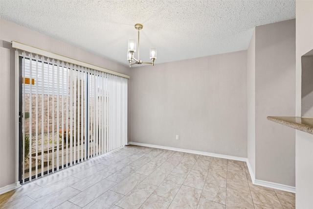 unfurnished dining area with a notable chandelier and a textured ceiling