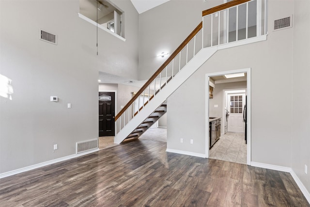 interior space with a high ceiling and hardwood / wood-style flooring