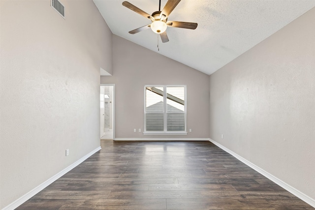 empty room featuring a textured ceiling, dark hardwood / wood-style flooring, ceiling fan, and lofted ceiling