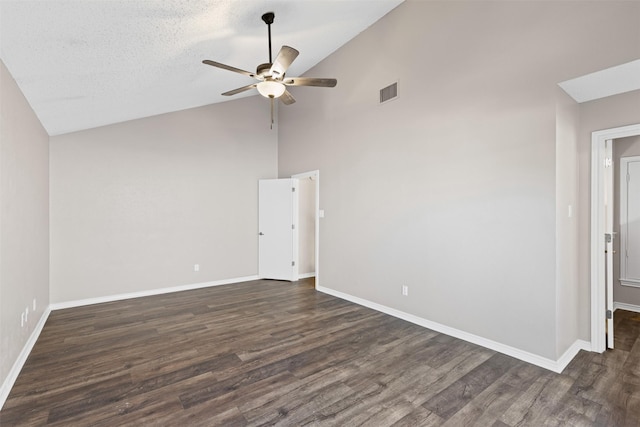 empty room with dark hardwood / wood-style floors, ceiling fan, a textured ceiling, and high vaulted ceiling