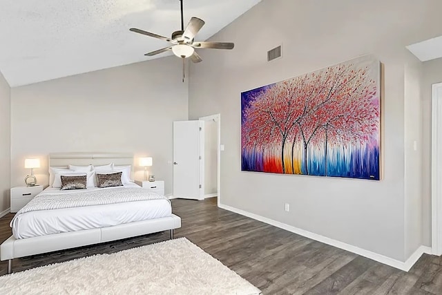 bedroom featuring ceiling fan, dark hardwood / wood-style floors, and high vaulted ceiling