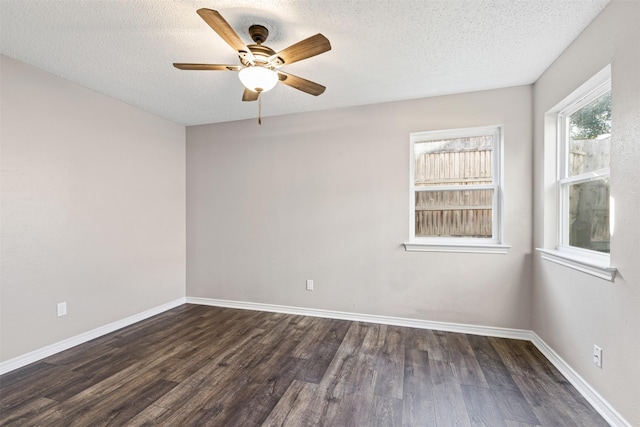 unfurnished room featuring dark hardwood / wood-style floors, ceiling fan, and a textured ceiling