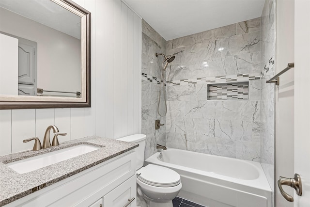 full bathroom featuring vanity, toilet, and tiled shower / bath